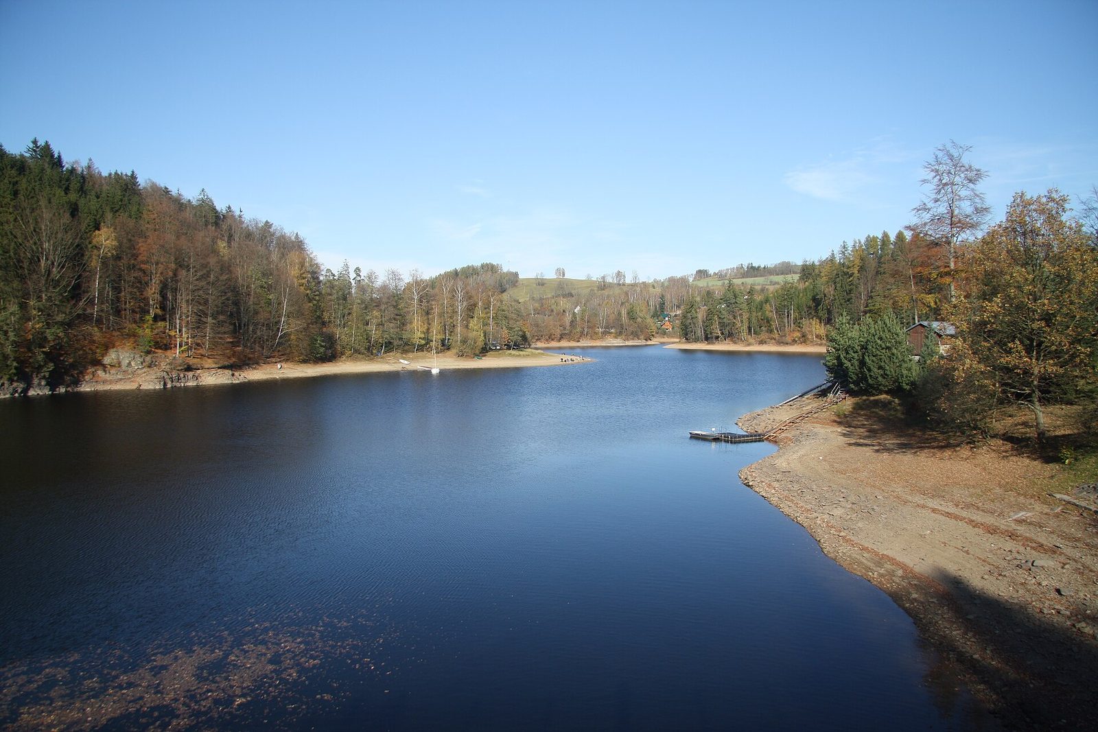 Přehrada Pastviny, klidná hladina a zalesněné břehy
